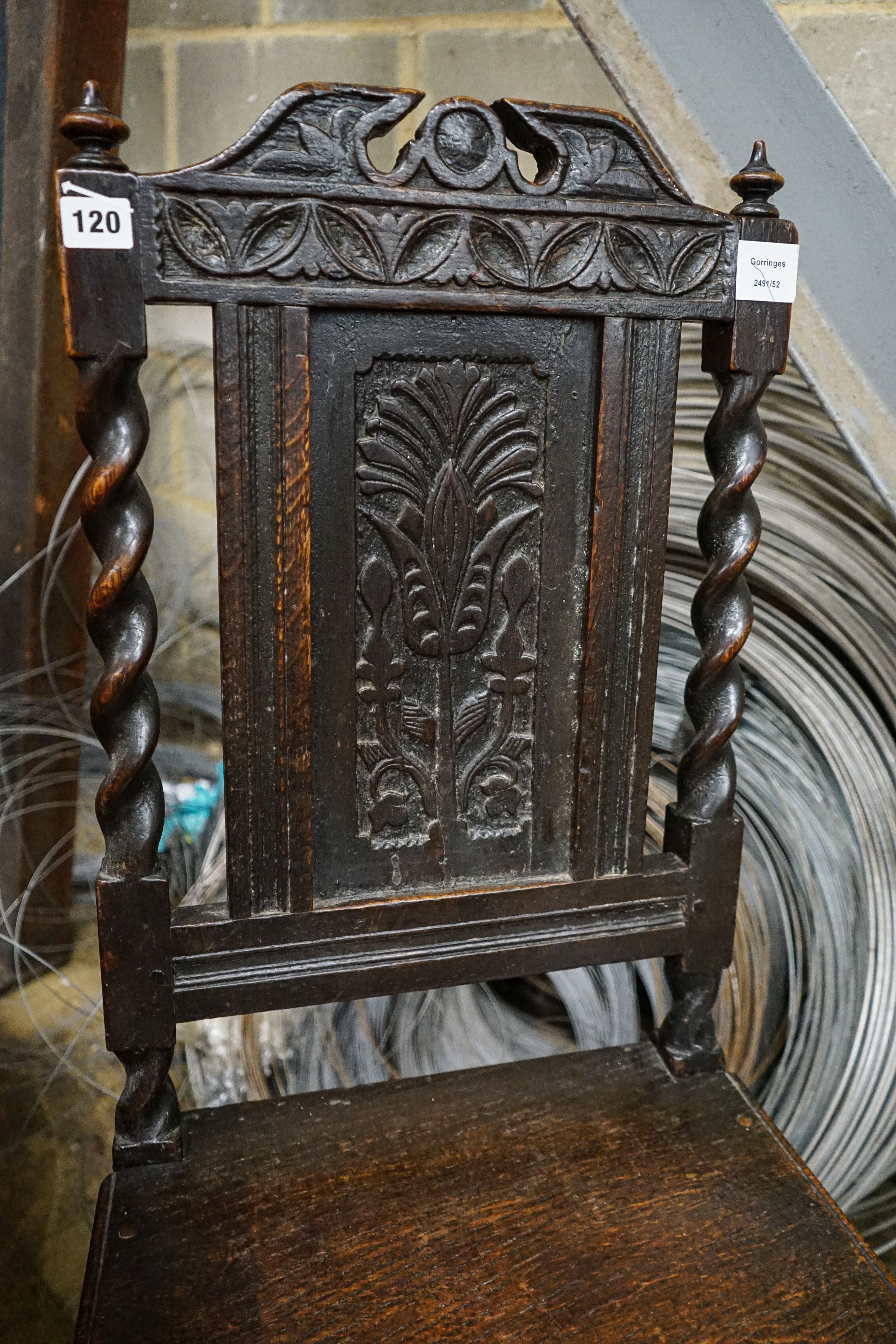 A 17th century oak dining chair, with carved panelled back, solid seat and barley twist stretchers, width 49cm, depth 39cm, height 96cm